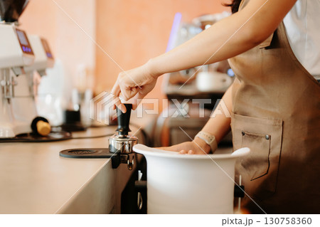 Explore professional Asian baristas brewing coffee, using notepads, digital tablets, and showcasing coffee Explore professional Asian baristas brewing coffee, using notepads, digital tablets, and showcasing coffee 130758360