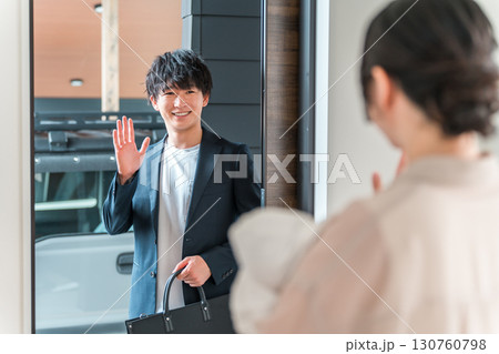 朝出勤する夫・旦那を玄関で見送りする赤ん坊を抱く若いアジア人女性・妻 朝出勤する夫・旦那を玄関で見送りする赤ん坊を抱く若いアジア人女性・妻 130760798