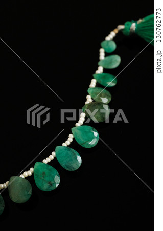 黒背景に映えるエメラルドとパールのブリオレットカットルース 130762773