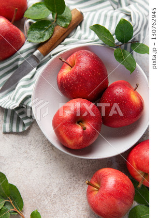Fresh red apples with water drops in bowl on kitchen table Fresh red apples with water drops in bowl on kitchen table 130762945
