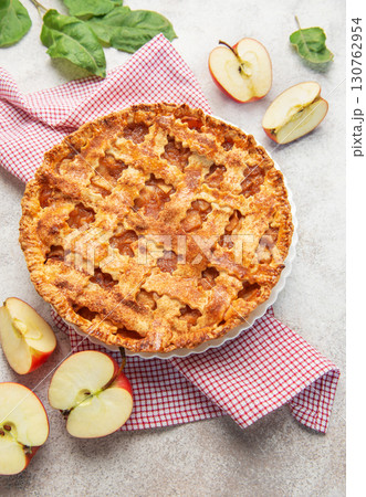 Delicious homemade apple pie decorated with fresh apple slices and leaves 130762954
