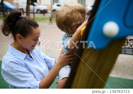 Mother and Child Enjoy Quality Time at the Playground Outdoors Mother and Child Enjoy Quality Time at the Playground Outdoors 130763723