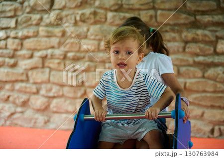 Children Enjoying a Wooden Play Structure at a Park Playground Children Enjoying a Wooden Play Structure at a Park Playground 130763984