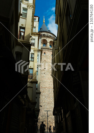 Istanbul, Turkey. View of Galata tower through the streets with tight buildings. Travel attraction. Islamic architecture Istanbul, Turkey. View of Galata tower through the streets with tight buildings. Travel attraction. Islamic architecture 130764180