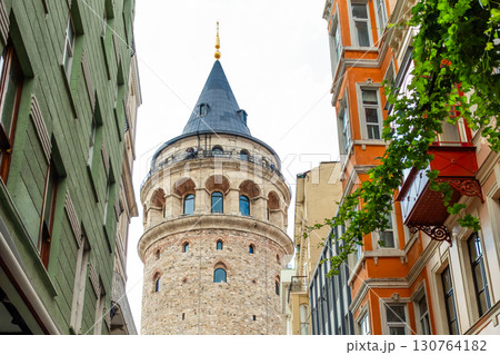 Istanbul, Turkey. View of Galata tower through the streets with tight buildings. Travel attraction. Islamic architecture Istanbul, Turkey. View of Galata tower through the streets with tight buildings. Travel attraction. Islamic architecture 130764182