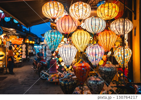 Traditional Asian lanterns glow with warm light creating festive magic and cultural charm, Colorful handmade lights illuminate space radiating beauty and heritage 130764217