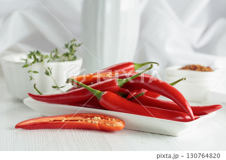 Fresh red chili peppers with on a white wooden table. 130764820