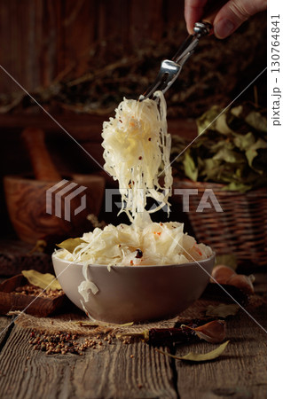 Traditional German sauerkraut on a old rustic wooden table. Traditional German sauerkraut on a old rustic wooden table. 130764841