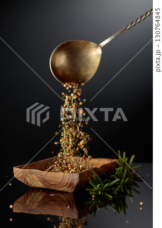 Fresh rosemary and dried spices on a black background. 130764845