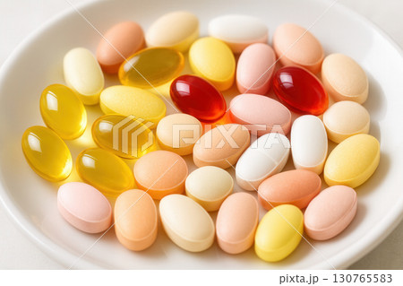Assorted Vitamins And Supplements On White Plate In Soft Daylight 130765583