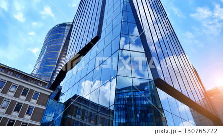 Modern sustainable glass office buildings. Exterior view of corporate headquarters glass buildings architecture.Glass windows in energy-efficient buildings. Financial business center buildings. Modern sustainable glass office buildings. Exterior view of corporate headquarters glass buildings architecture.Glass windows in energy-efficient buildings. Financial business center buildings. 130765722