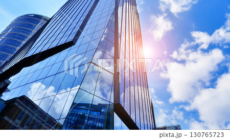 Modern sustainable glass office buildings. Exterior view of corporate headquarters glass buildings architecture.Glass windows in energy-efficient buildings. Financial business center buildings. Modern sustainable glass office buildings. Exterior view of corporate headquarters glass buildings architecture.Glass windows in energy-efficient buildings. Financial business center buildings. 130765723
