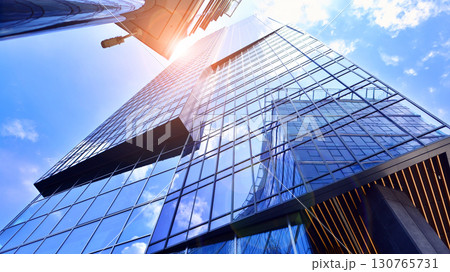 Modern sustainable glass office buildings. Exterior view of corporate headquarters glass buildings architecture.Glass windows in energy-efficient buildings. Financial business center buildings. Modern sustainable glass office buildings. Exterior view of corporate headquarters glass buildings architecture.Glass windows in energy-efficient buildings. Financial business center buildings. 130765731