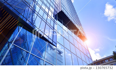 Modern sustainable glass office buildings. Exterior view of corporate headquarters glass buildings architecture.Glass windows in energy-efficient buildings. Financial business center buildings.  130765732