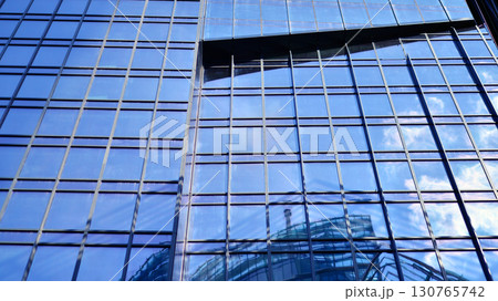 Modern sustainable glass office buildings. Exterior view of corporate headquarters glass buildings architecture.Glass windows in energy-efficient buildings. Financial business center buildings.  130765742