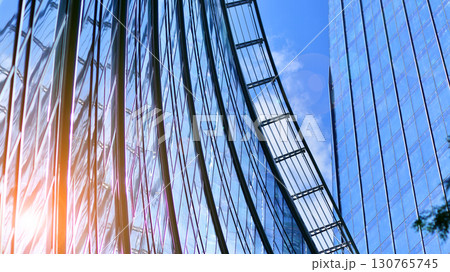 Modern sustainable glass office buildings. Exterior view of corporate headquarters glass buildings architecture.Glass windows in energy-efficient buildings. Financial business center buildings.  130765745