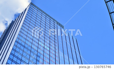 Modern sustainable glass office buildings. Exterior view of corporate headquarters glass buildings architecture.Glass windows in energy-efficient buildings. Financial business center buildings.  130765746