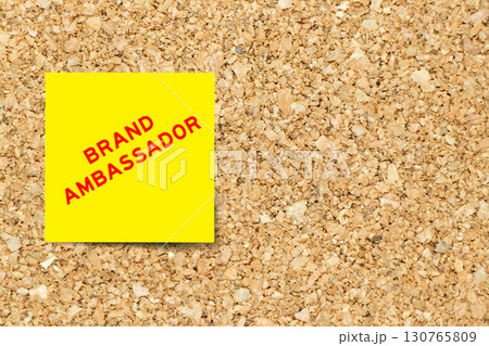 Yellow note paper with word brand ambassador on cork board background with copy space Yellow note paper with word brand ambassador on cork board background with copy space 130765809