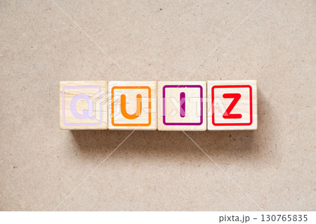 Alphabet letter block in word quiz on wood background 130765835