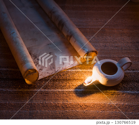 Old oil lamp and scroll Old oil lamp and scroll 130766519