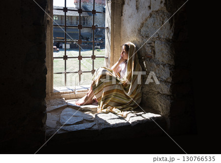 Lone girl sitting in the castle 130766535