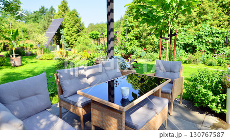 Modern aluminum pergola with stylish garden furniture in a beautiful garden. Modern aluminum pergola with stylish garden furniture in a beautiful garden. 130767587