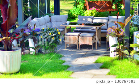 Modern aluminum pergola with stylish garden furniture in a beautiful garden. Modern aluminum pergola with stylish garden furniture in a beautiful garden. 130767593