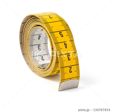 Yellow measuring tape curled up on white background 130767854