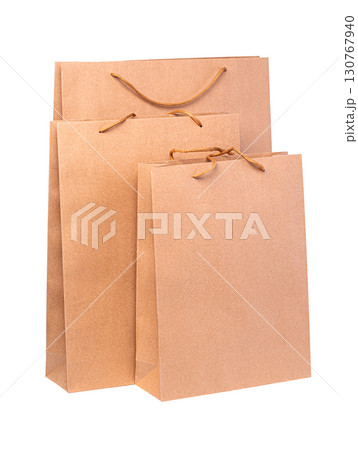 Three brown paper shopping bags with transparent background 130767940