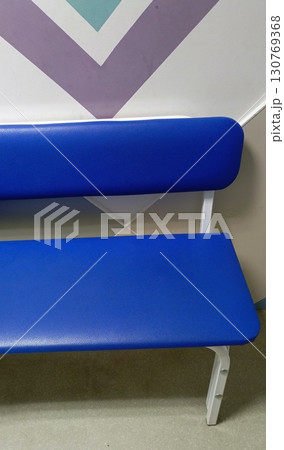 Simple public bench in a minimalist style in blue, purple, and teal colors used for a waiting area Simple public bench in a minimalist style in blue, purple, and teal colors used for a waiting area 130769368