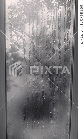 Foggy window in an abstract style in black and white representing a somber and mysterious mood 130769369