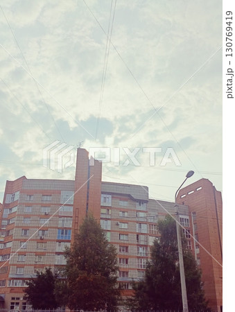 Multi-story block building in a brutalist style in muted colors representing post-soviet architecture Multi-story block building in a brutalist style in muted colors representing post-soviet architecture 130769419