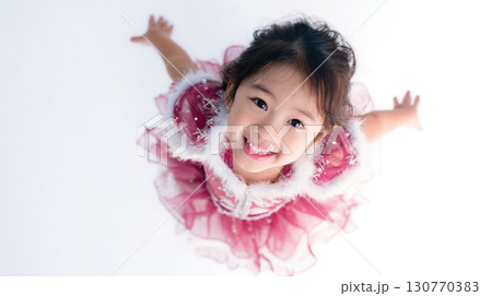 Cheerful Asian Girl Celebrating New Year in Festive Costume 130770383