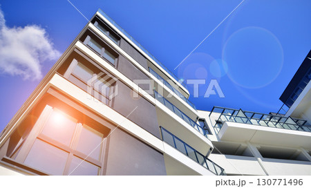Modern apartment buildings on a sunny day with a blue sky. Facade of a modern apartment building. Modern residential apartment building complex condo. 130771496