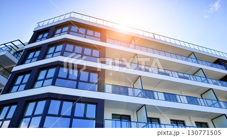 Modern apartment buildings on a sunny day with a blue sky. Facade of a modern apartment building. Modern residential apartment building complex condo. Modern apartment buildings on a sunny day with a blue sky. Facade of a modern apartment building. Modern residential apartment building complex condo. 130771505
