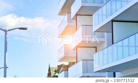 Modern apartment buildings on a sunny day with a blue sky. Facade of a modern apartment building. Modern residential apartment building complex condo. Modern apartment buildings on a sunny day with a blue sky. Facade of a modern apartment building. Modern residential apartment building complex condo. 130771512