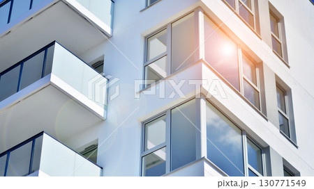 Modern apartment buildings on a sunny day with a blue sky. Facade of a modern apartment building. Modern residential apartment building complex condo. 130771549