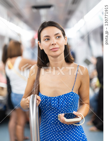 Young girl standing in wagon holding phone in hand 130771915