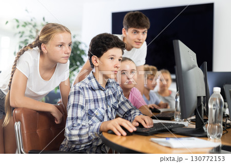 Group of students working at computer in classroom 130772153