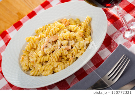 Delicious pasta of smoked salmon at white plate on table 130772321