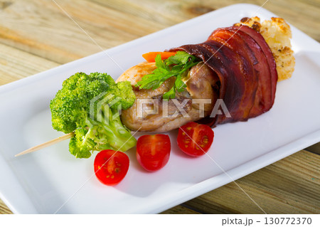 Grilled quail with Iberian ham fried on skewers with vegetables Grilled quail with Iberian ham fried on skewers with vegetables 130772370