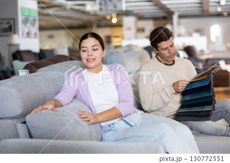Happy couple choose a new sofa Happy couple choose a new sofa 130772551