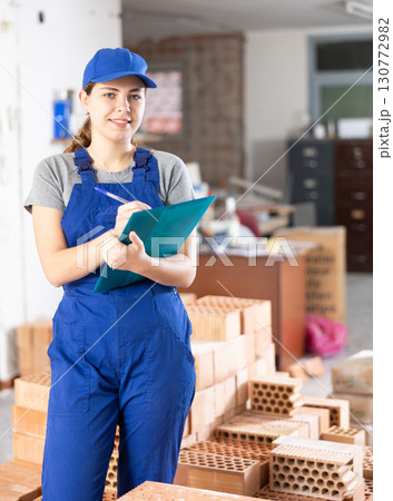 Woman architect taking notes on construction site 130772982