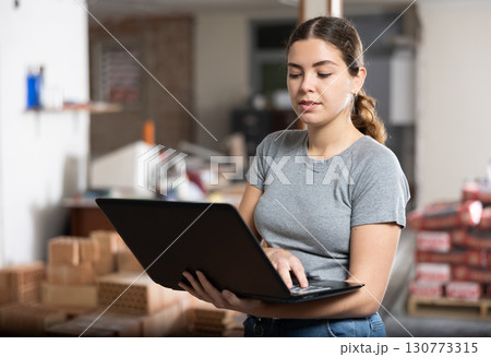 Woman with laptop on indoor construction site Woman with laptop on indoor construction site 130773315