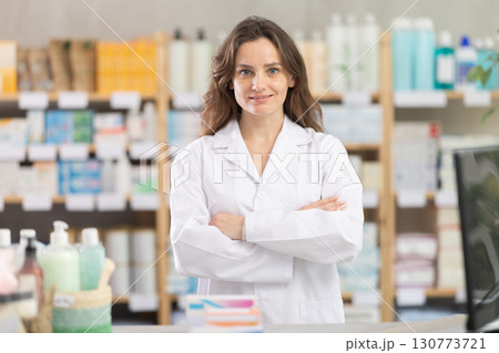 Portrait of friendly pharmacist woman inviting to visit drugstore 130773721
