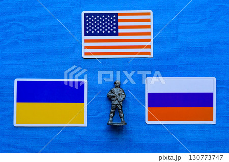 Flags of Russia, Ukraine and the USA on a blue background. The Russian-Ukrainian conflict. Flags of Russia, Ukraine and the USA on a blue background. The Russian-Ukrainian conflict. 130773747