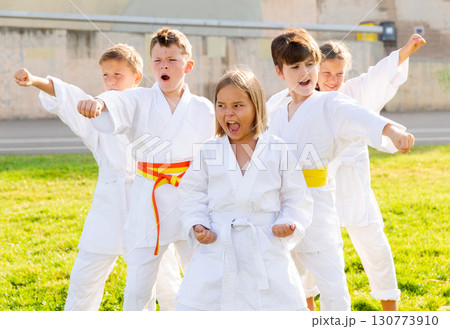 Group of preteen children practicing karate in summer park 130773910