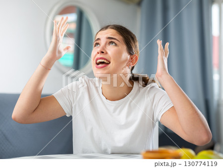Stressed young woman suffering from noisy neighbors Stressed young woman suffering from noisy neighbors 130774119
