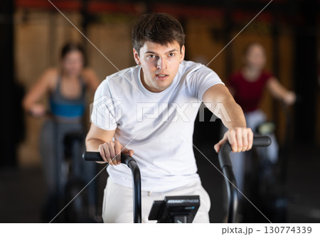 Man training on an airbike Man training on an airbike 130774339