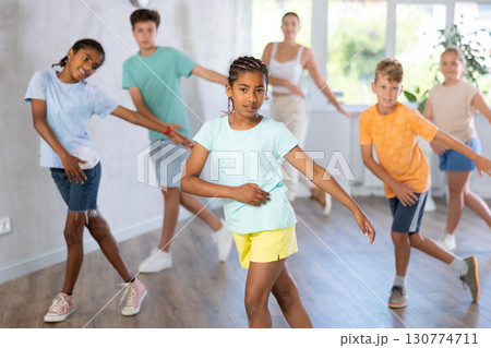 African girl perform social dance vogue with friends and female teacher in background African girl perform social dance vogue with friends and female teacher in background 130774711